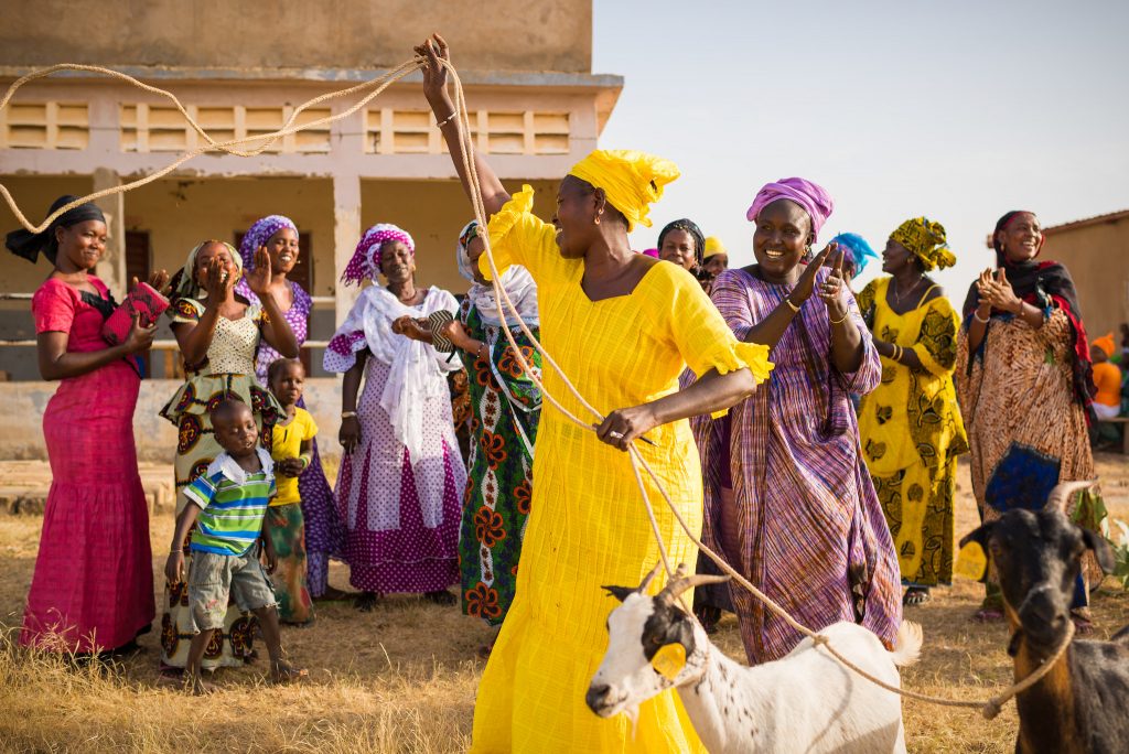 Photo of crowd of women with a goat