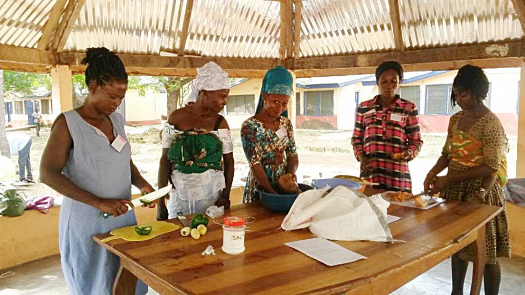 Photo of women performing cooking demonstration