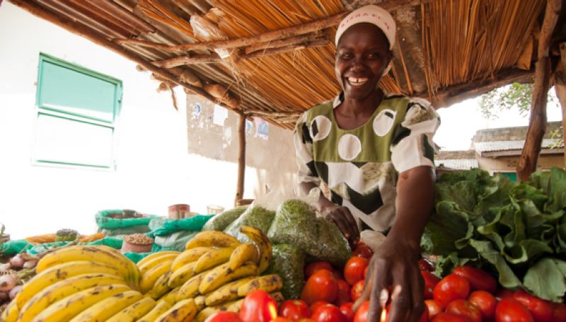 A woman displays her crops for sale at a market