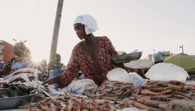 A woman displays her crops for sale at a market