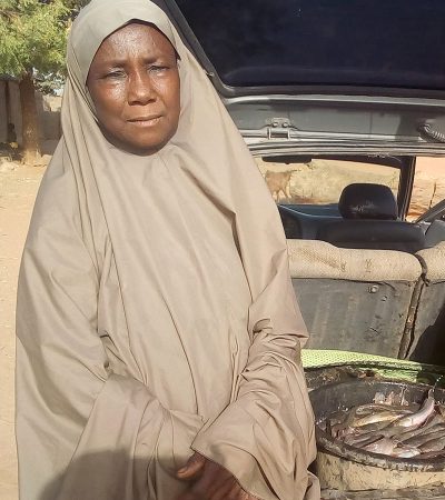 Hajia Fatima Aliu with fish harvested from her rice-fish site.